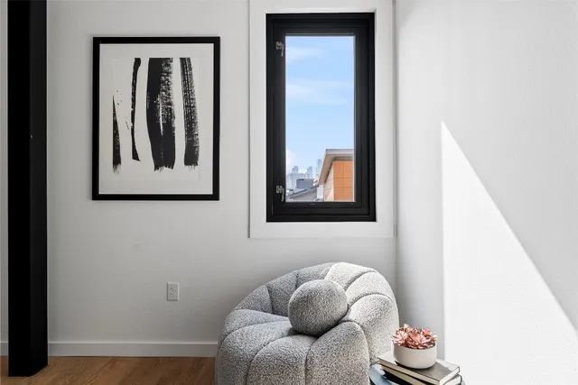 a living room with furniture and white wall