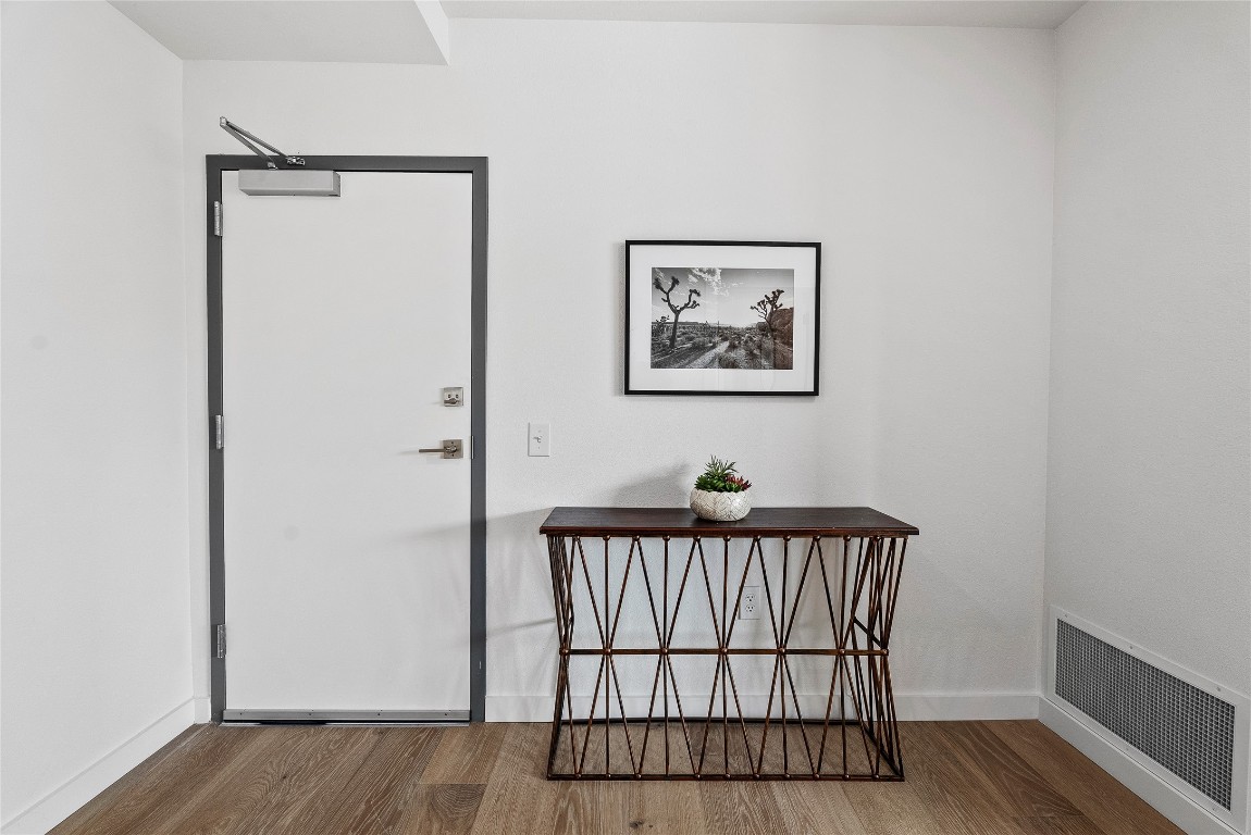 1800 East 4th Street, Unit 396 Austin, TX 78702 - Photo 17 of 20 a view of a hallway with wooden floor and a bathroom