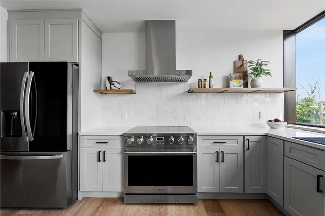 a kitchen with stainless steel appliances a stove and a refrigerator