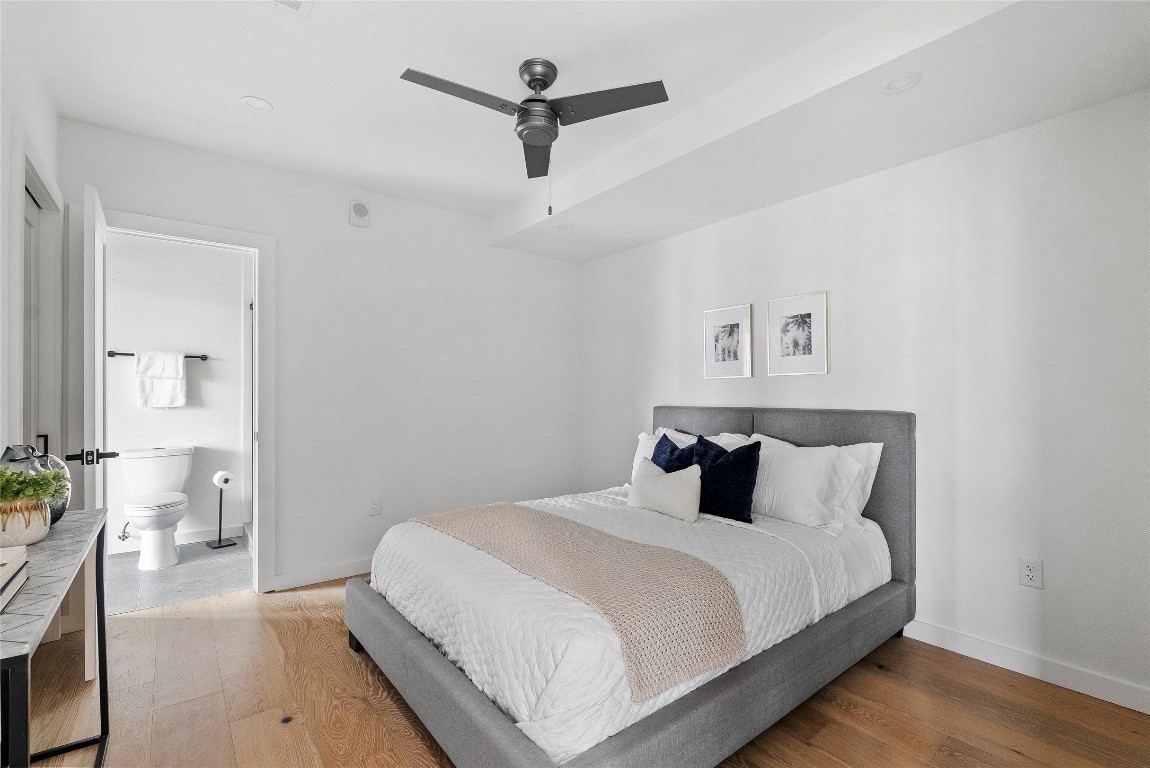 1800 East 4th Street, Unit 396 Austin, TX 78702 - Photo 5 of 20 a bedroom with a large bed and a chandelier