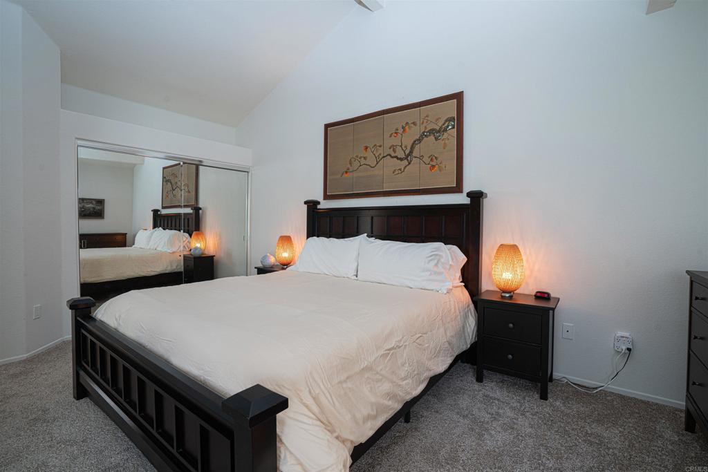4717 Majorca Way Oceanside, CA 92056 - Photo 12 of 33 a bedroom with a bed and lamp