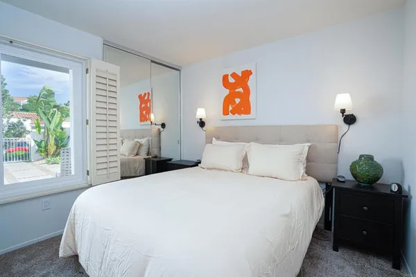 a bedroom with a bed and a window