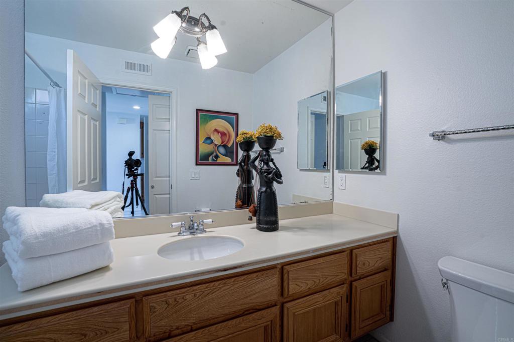 4717 Majorca Way Oceanside, CA 92056 - Photo 16 of 33 a bathroom with a sink and a mirror