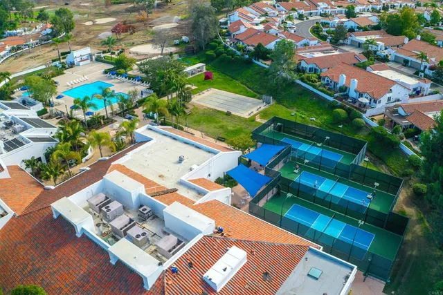 an aerial view of multiple houses with yard