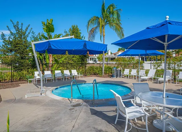 a view of a swimming pool with outdoor seating