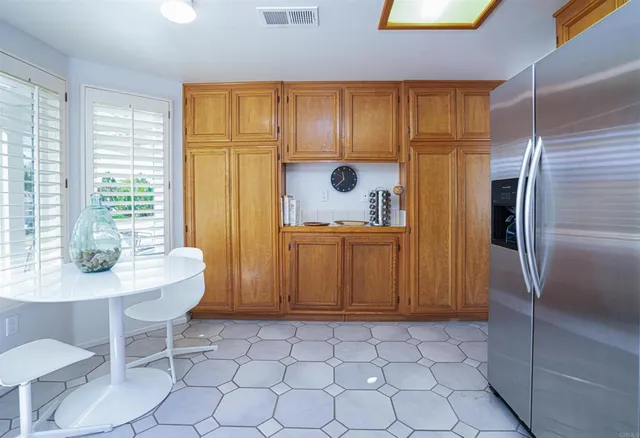 a kitchen with stainless steel appliances a refrigerator and a table