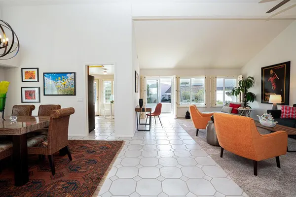 a living room with fireplace furniture and a large window