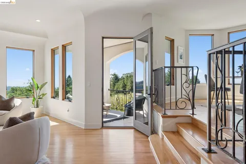 a large bedroom with a bed and a large window