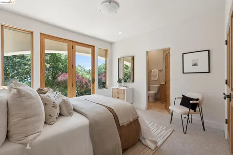 a view of a white house with a yard and large tree