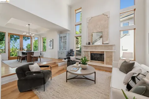a living room with furniture potted plant and a large window