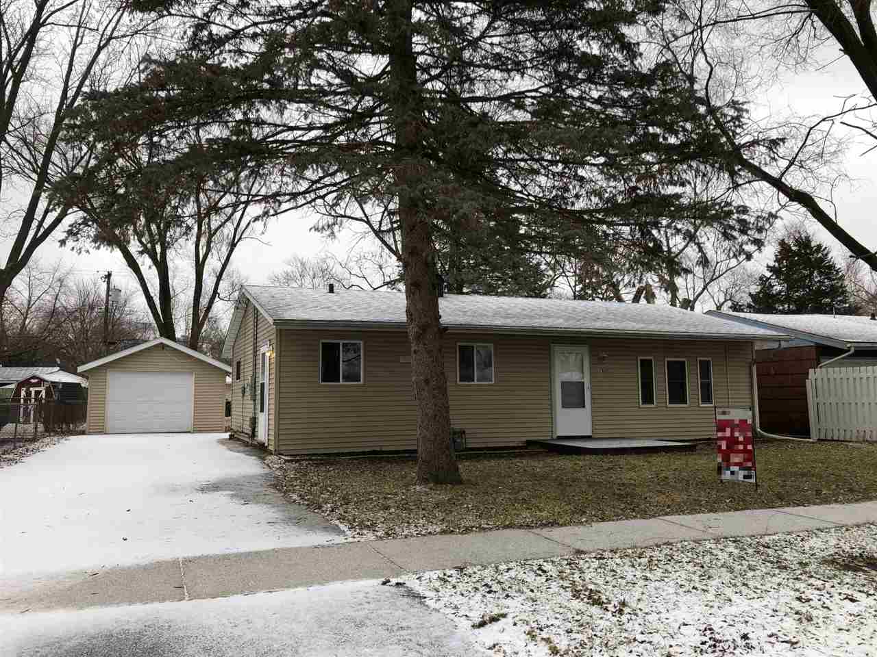 7801 Randy Road Machesney Park, IL 61115 - Photo 1 of 25 a front view of a house with garden