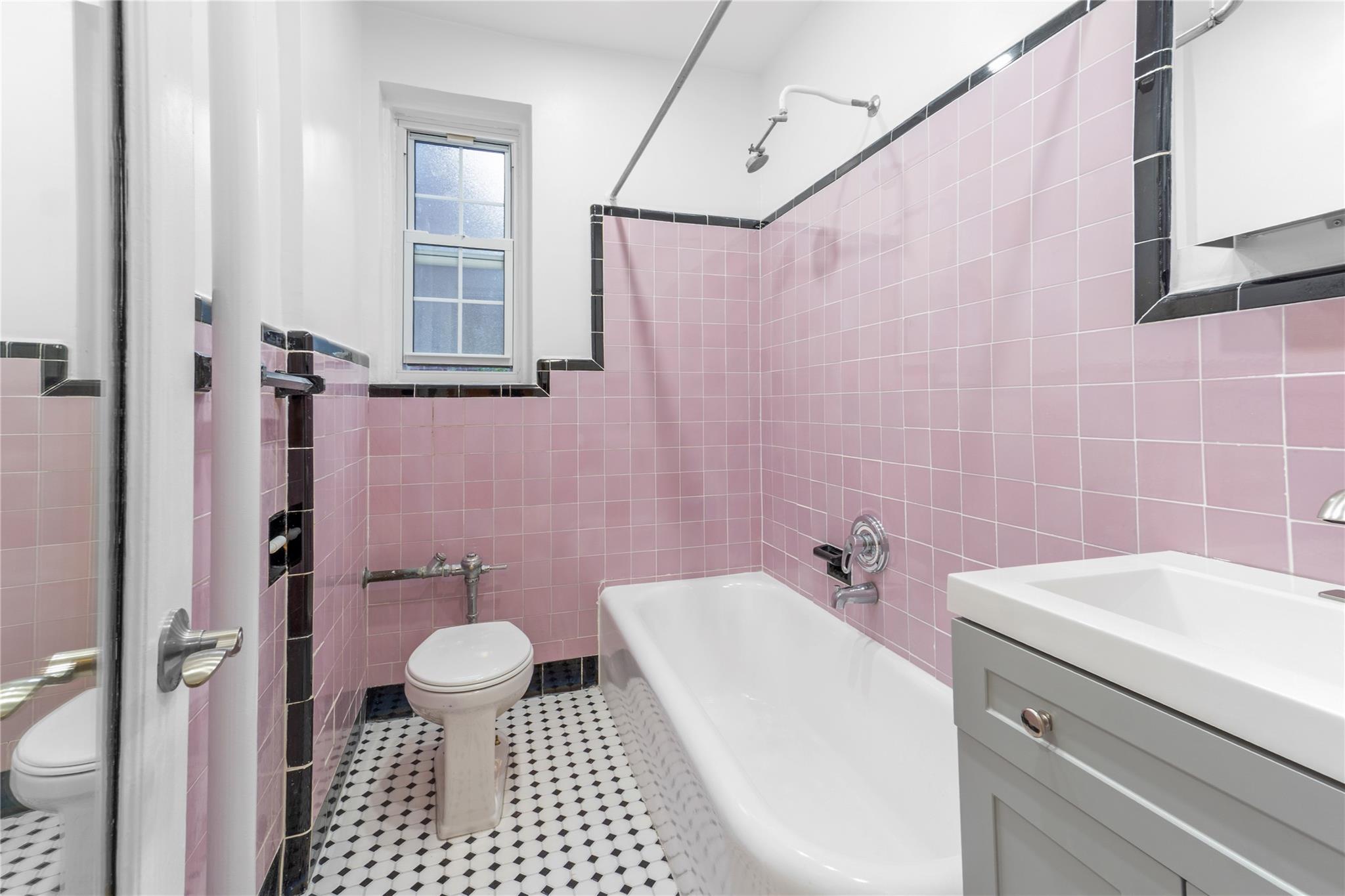 110-07 73rd Road, Unit 4D Queens, NY 11375 - Photo 12 of 16 Bathroom featuring toilet, tile walls, vanity, shower / bath combination, and tile patterned flooring