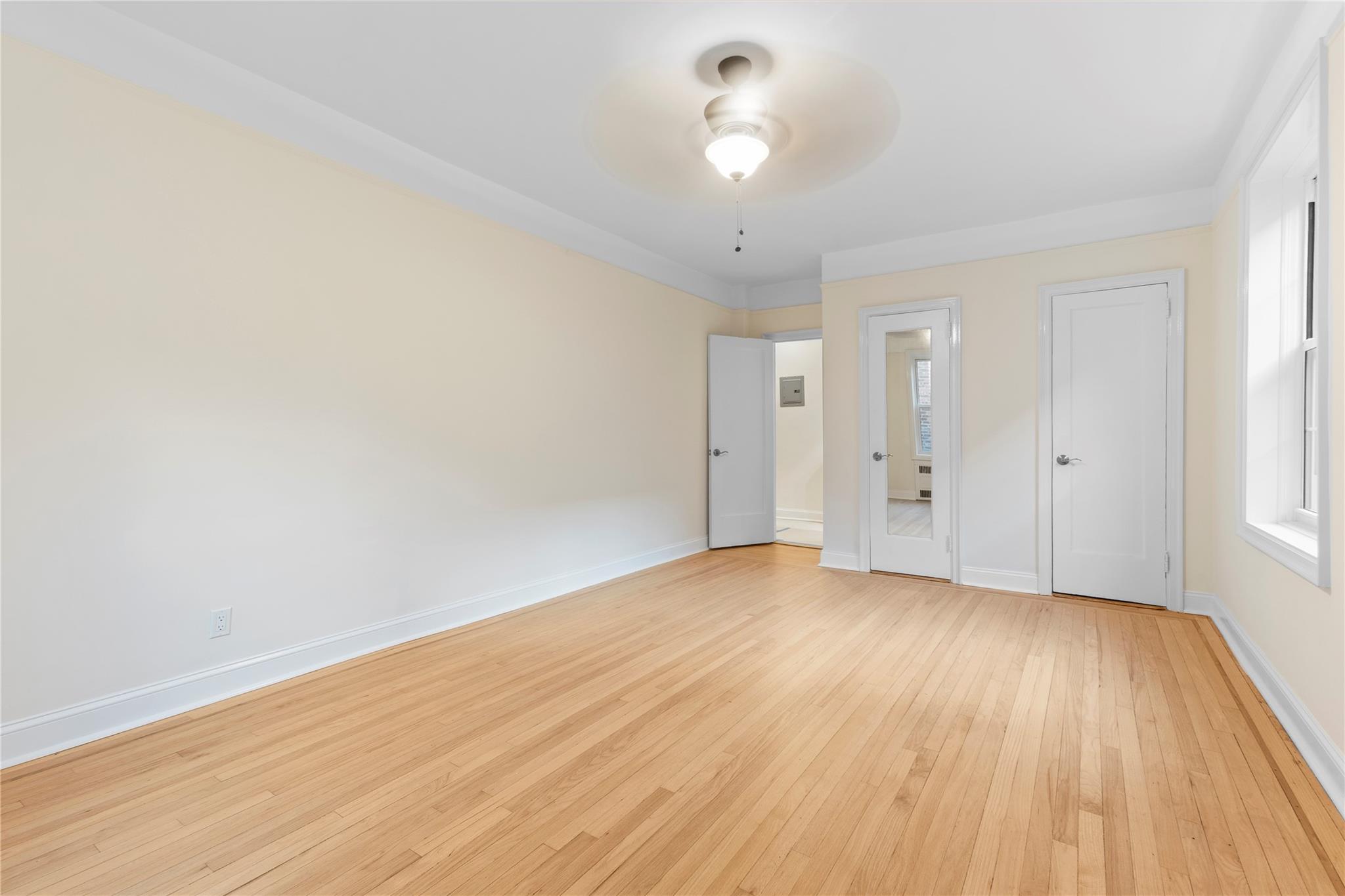110-07 73rd Road, Unit 4D Queens, NY 11375 - Photo 6 of 16 Unfurnished bedroom with light wood-style floors and baseboards