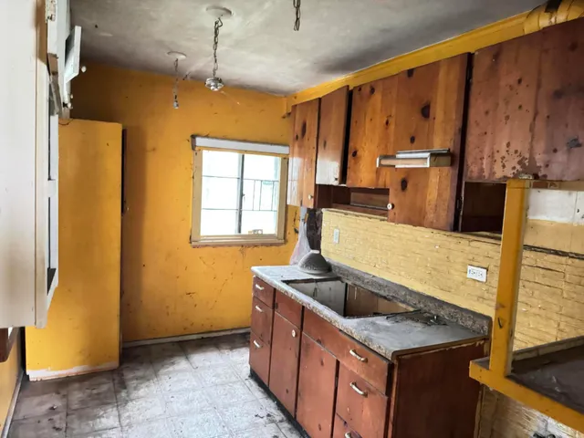 a kitchen with stainless steel appliances granite countertop a sink a stove and a refrigerator