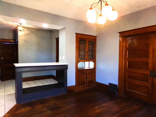 a room with wooden floor and a fireplace