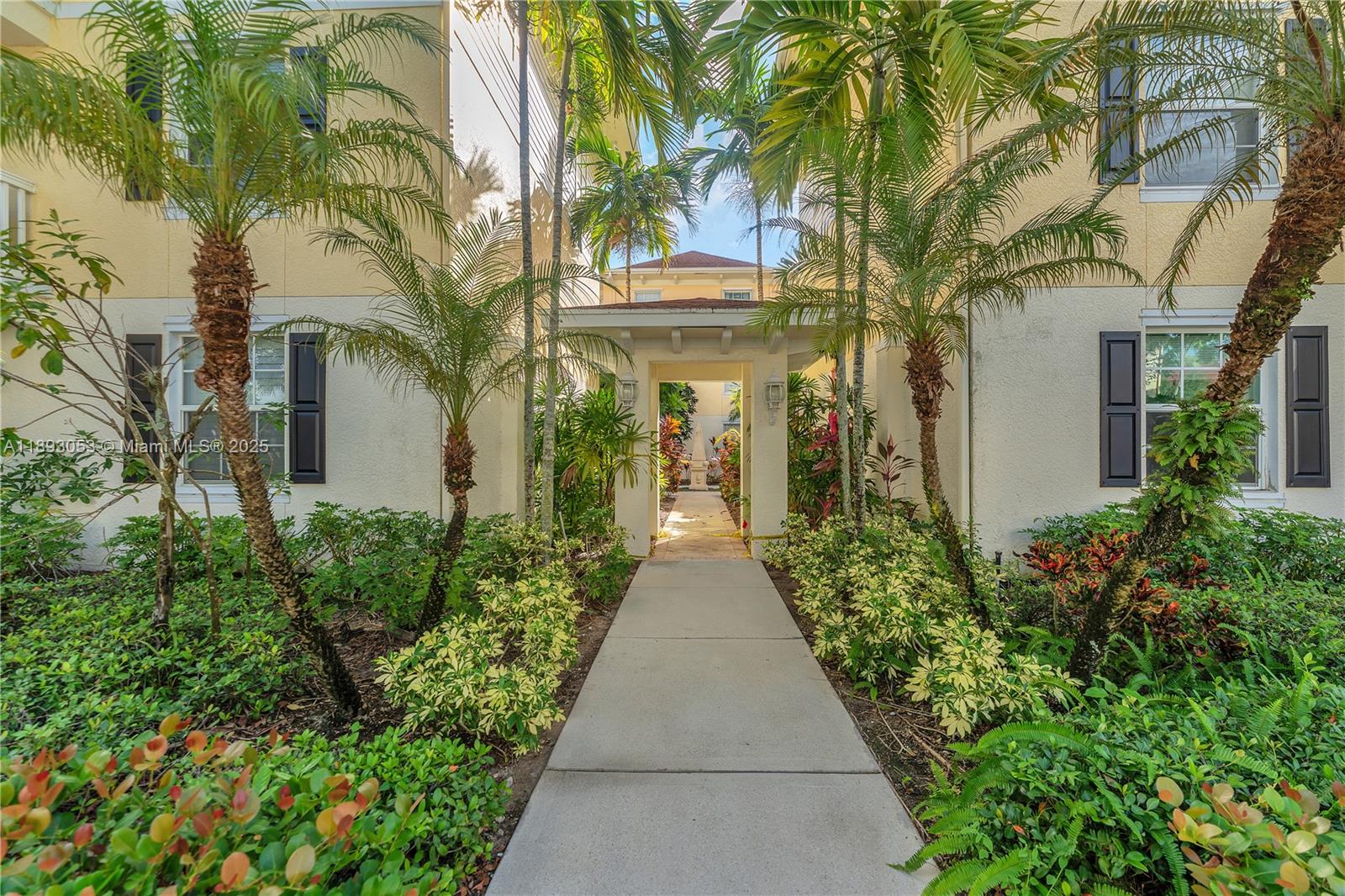 275 Murcia Drive, Unit 104 Jupiter, FL 33458 - Photo 16 of 26 a view of a pathway with house on both side