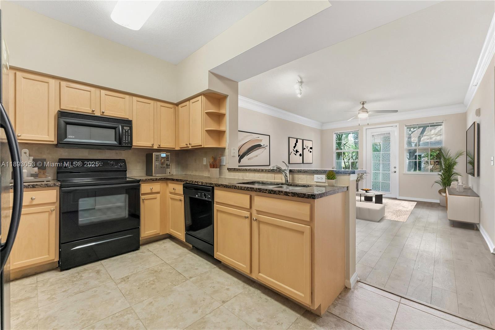 275 Murcia Drive, Unit 104 Jupiter, FL 33458 - Photo 6 of 26 a kitchen with stainless steel appliances granite countertop a stove top oven a sink dishwasher and a refrigerator
