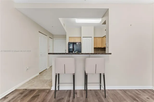 a kitchen with a sink cabinets and wooden floor