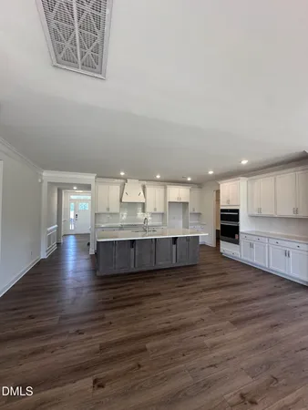 a large kitchen with kitchen island a sink stainless steel appliances and cabinets