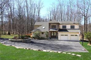 a front view of a house with a garden and yard
