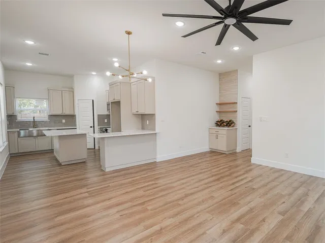 a view of kitchen with sink and refrigerator