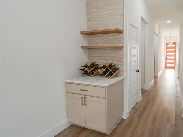 a white cabinets with wooden floor