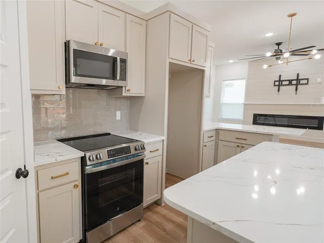 a kitchen with a stove and a microwave