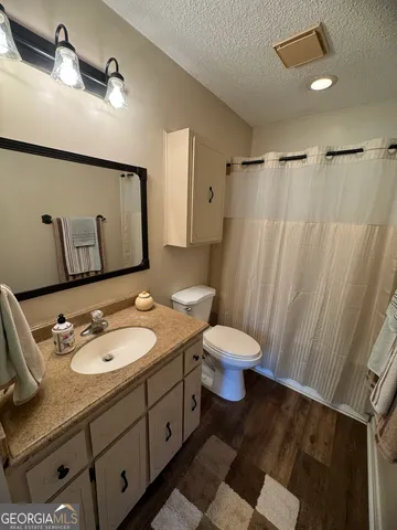 a large kitchen with stainless steel appliances granite countertop a stove a sink and a microwave