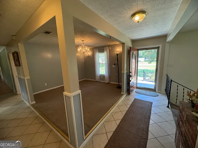 a view of a hallway with wooden floor and chair