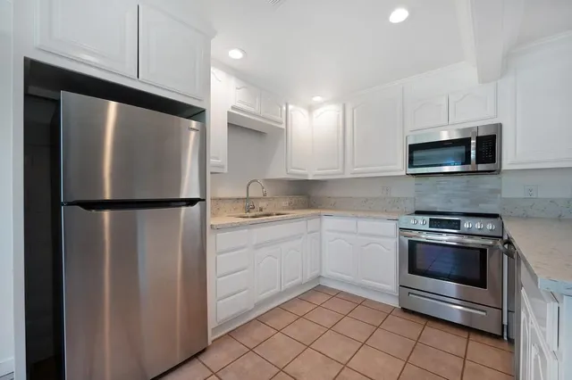 a kitchen with a refrigerator stove and microwave
