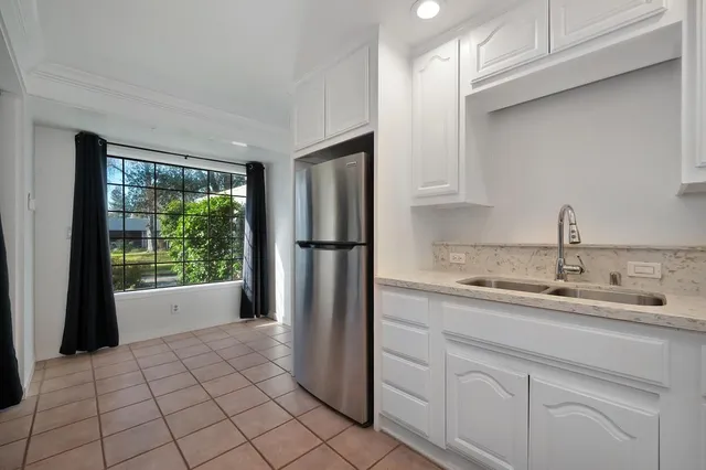 a kitchen with a sink a refrigerator and a stove