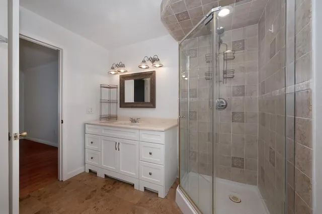 a bathroom with a shower toilet sink and mirror