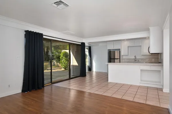 a view of a kitchen with kitchen island wooden floor and window