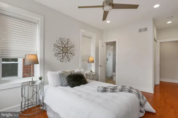 a bedroom with a bed dresser and a window