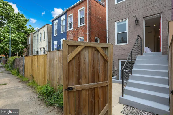 a view of a house with wooden fence