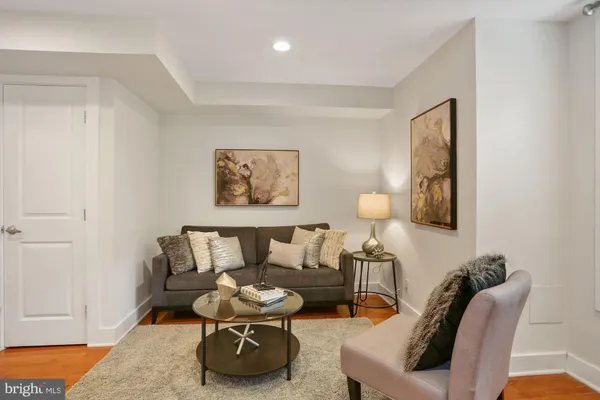 a living room with furniture and a lamp