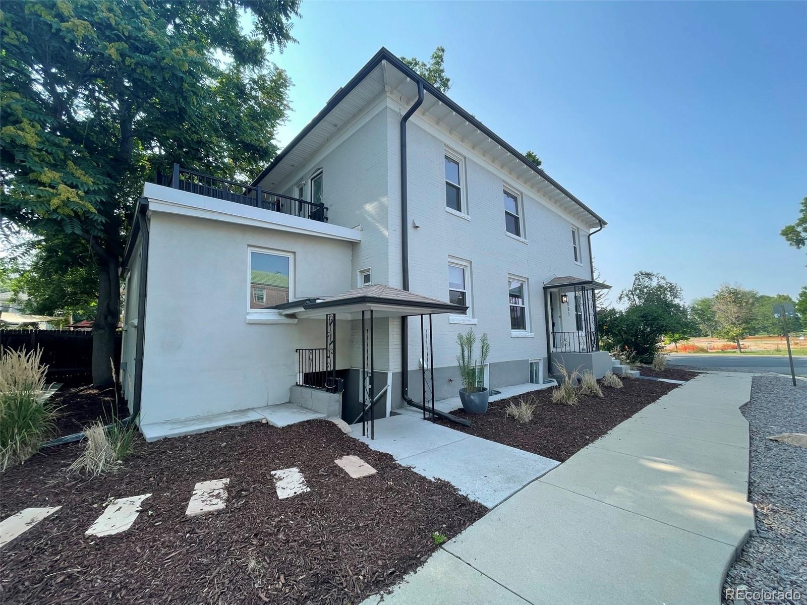 1691 Monroe Street Denver, CO 80206 - Photo 2 of 31 a front view of a house with yard