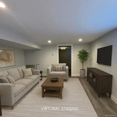 a living room with furniture a flat screen tv and a fireplace