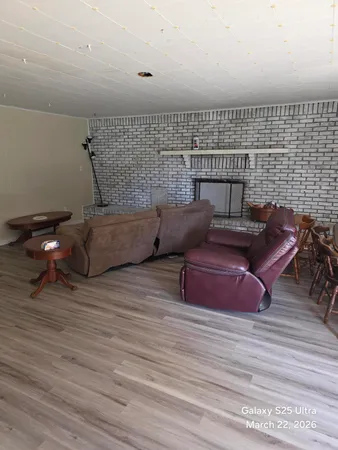 a living room with hard wood floors and a wooden floor