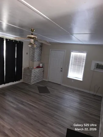 a view of a room with wooden floor