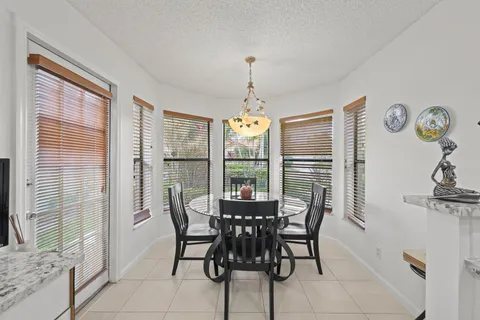 a view of a dining room with furniture window and outside view
