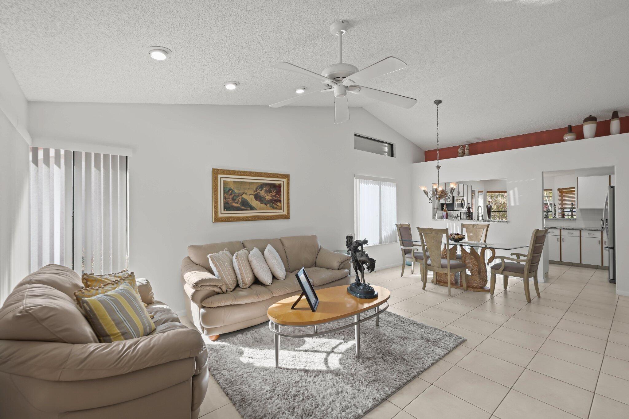 10678 Santa Laguna Drive Boca Raton, FL 33428 - Photo 10 of 40 a living room with furniture and a large window