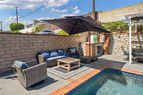 a roof deck with table and chairs under an umbrella