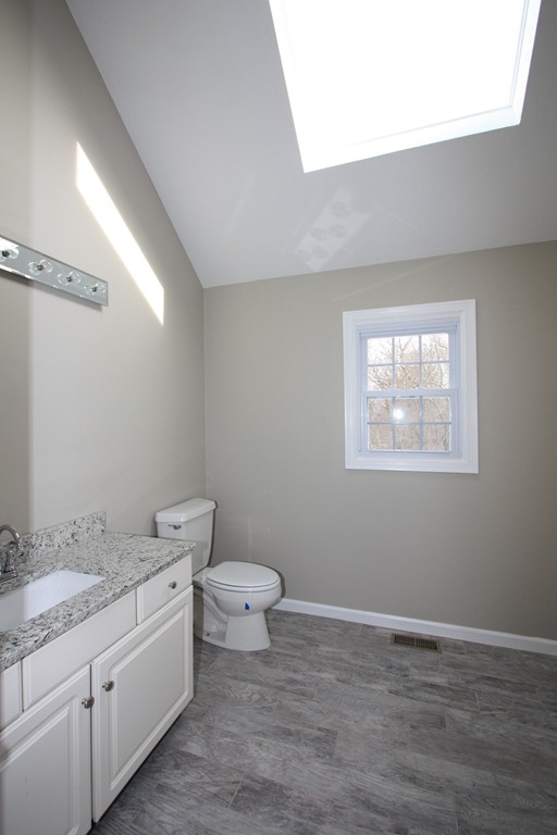14 Cedar Hill Road Sutton, MA 01590 - Photo 12 of 16 a bathroom with a granite countertop sink mirror vanity and toilet