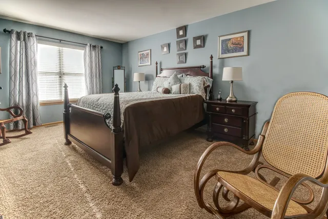 a bedroom with a bed and dresser