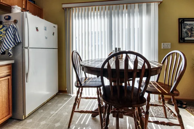 a view of a dining room with furniture and a window