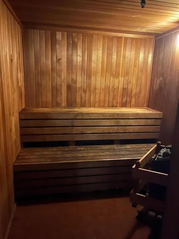 a room with gym equipment and large mirror