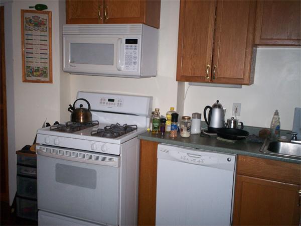 57-59 Myrtle Street Somerville, MA 02145 - Photo 18 of 30 a kitchen with granite countertop a stove sink and cabinets