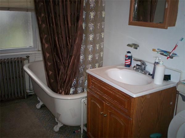 57-59 Myrtle Street Somerville, MA 02145 - Photo 21 of 30 a bathroom with a sink a mirror and a toilet