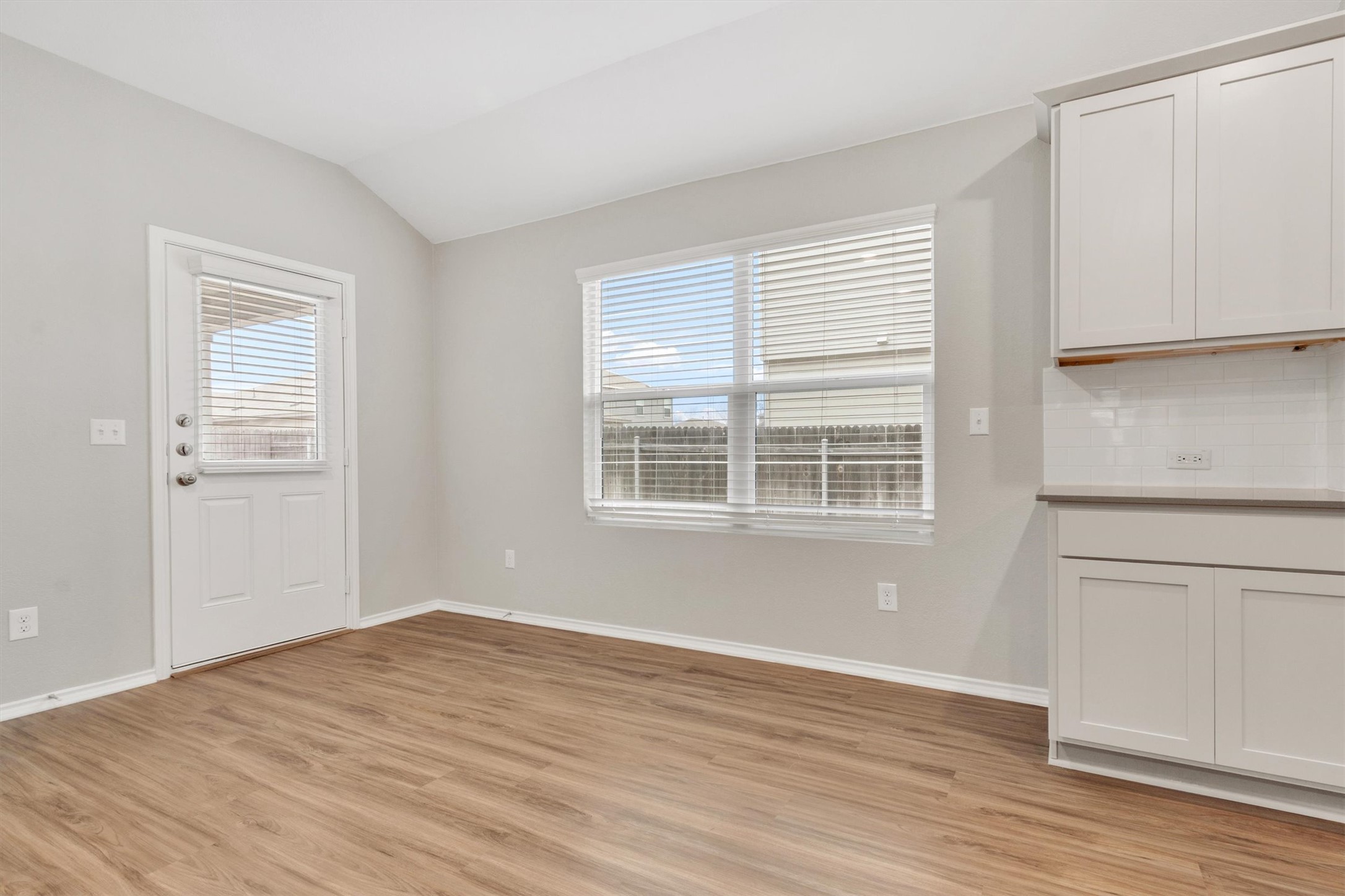 301 Blue Springs Pass Kyle, TX 78640 - Photo 15 of 20 Unfurnished dining area with lofted ceiling and light wood-type flooring
